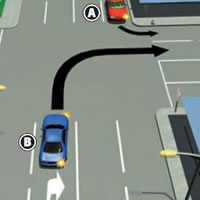Picture of two cars turning into the same road at a laned intersection